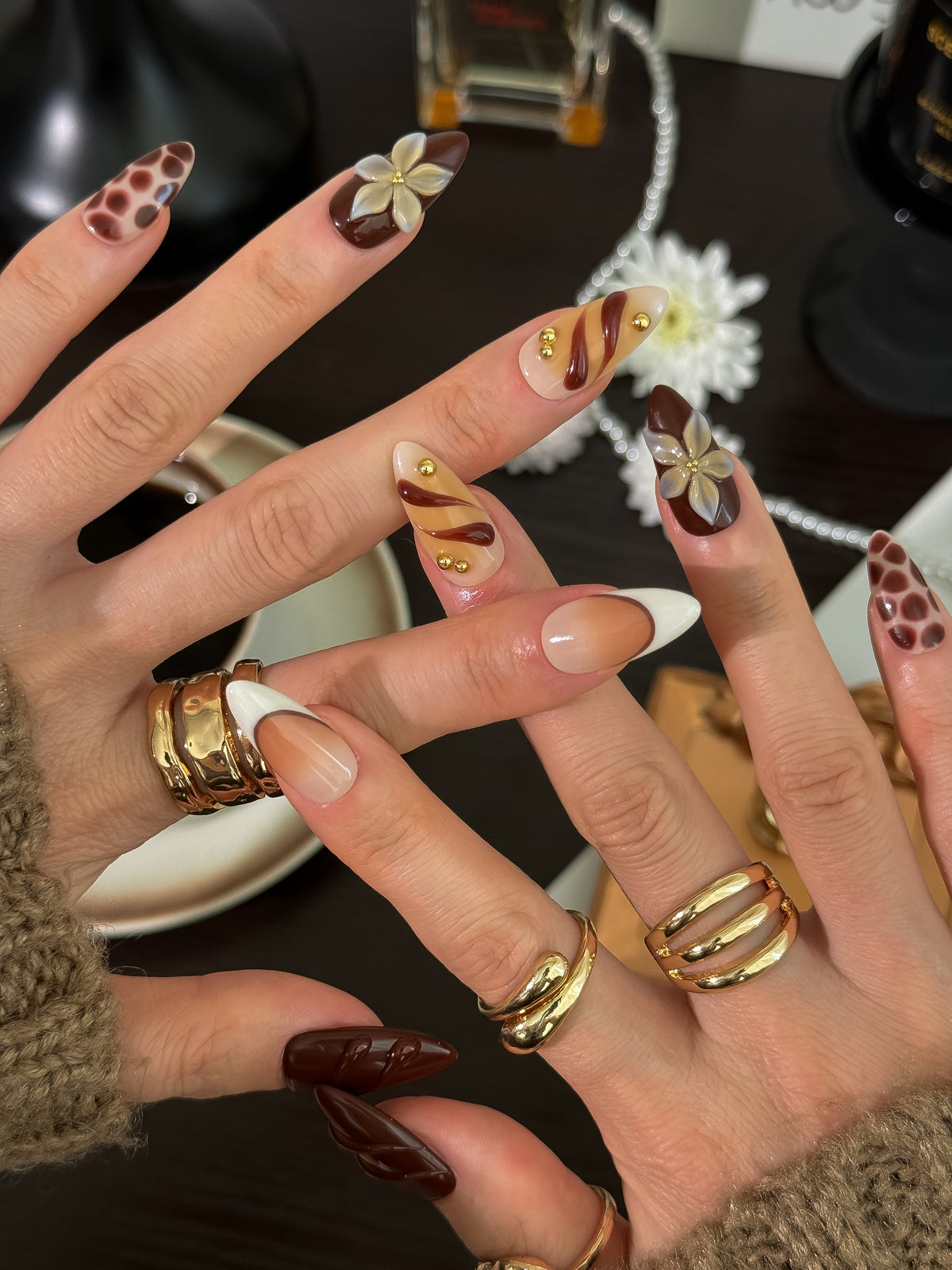Cocoa & Gold Reverie press-on nails on hand