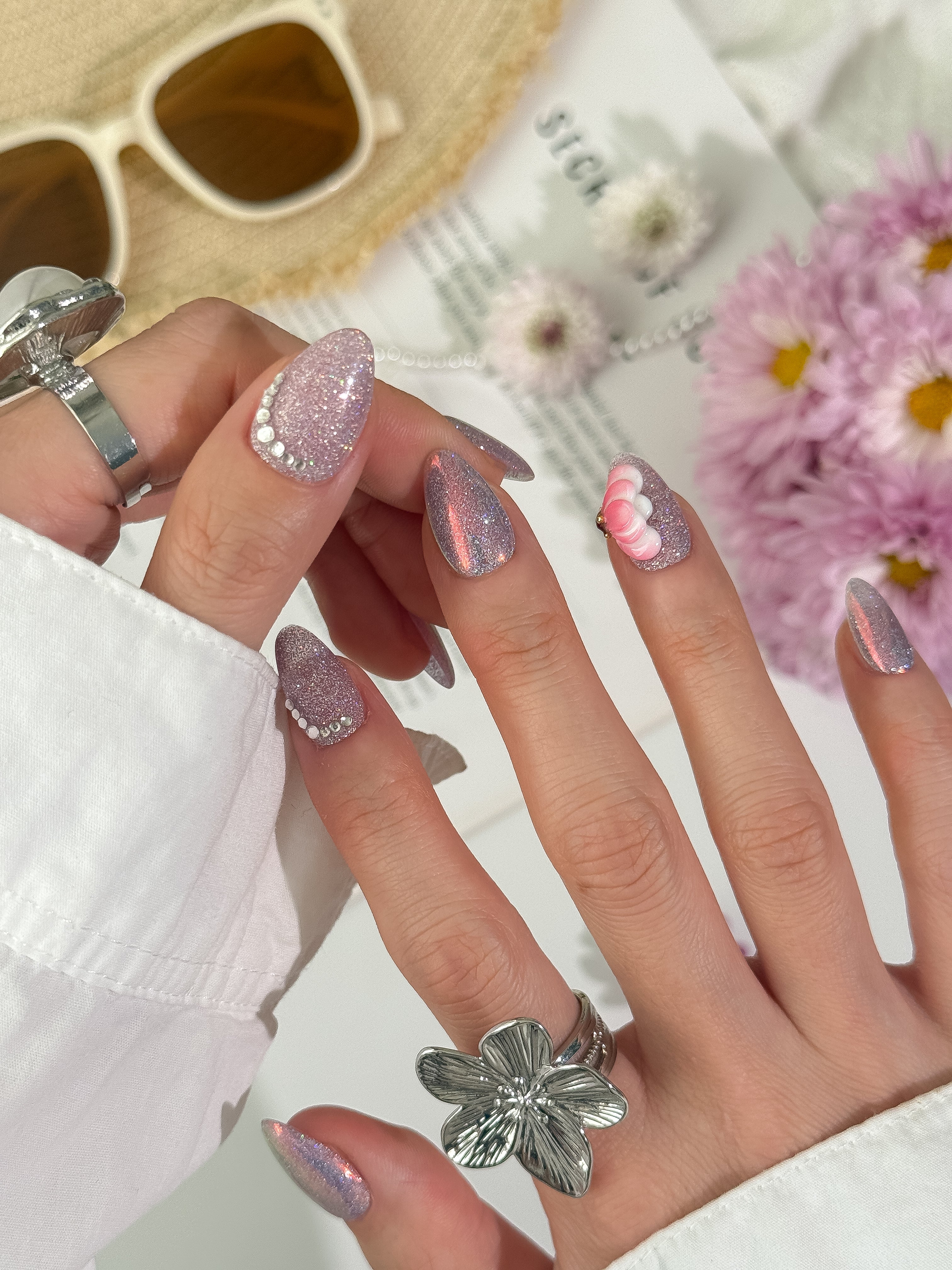 Stardust Bloom press-on nails on hand